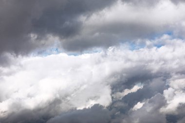 Vast expanse of cumulus clouds, showcasing a mix of light and shadow. Layers of puffy white and gray clouds, hinting at a dynamic sky. Cloudy sky, with a mix of light and dark gray clouds clipart