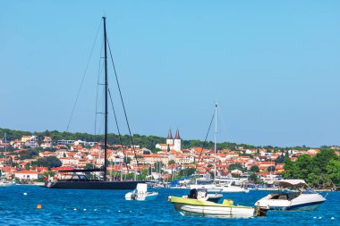 Hırvatistan 'ın Medulin kentinin cazibesi, lüks yatlar, yelkenliler ve kırmızı çatılı evleri olan pitoresk kasabaların yer aldığı çarpıcı kıyı sahneleriyle. Kristal mavi sular ve sakin liman Akdeniz kaçışı yarattı