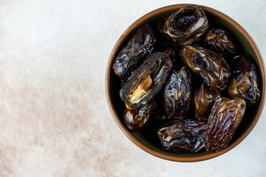Dates fruit in bowl on white background. Dried organic Superfood.