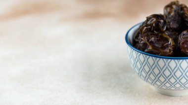 Dates fruit in bowl on white background. Dried organic Superfood.