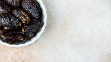 Dates fruit in bowl on white background. Dried organic Superfood.