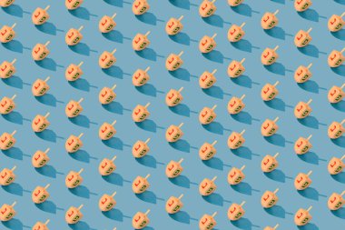 Jewish holiday Hanukkah concept. Wooden dreidel (spinning top) on blue background.