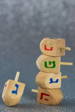 Jewish holiday Hanukkah concept. Wooden dreidel (spinning top) on white background.