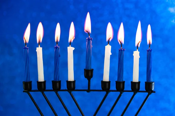 Jewish holiday Hanukkah concept. Menorah - traditional candelabrum or hanukkiah with lights and burning candles.