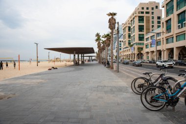 2.01.2023, Tel Aviv, Israel. Tel-Aviv city background. Street near the beach and Mediterranean Sea. Buildings, hotels, people and cars. City lifestyle. Israel Tourism.