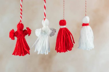 Traditional Martisor - symbol of holiday 1 March, Martenitsa, Baba Marta, beginning of spring and seasons changing in Romania, Bulgaria, Moldova. Greeting and post card for holidays.