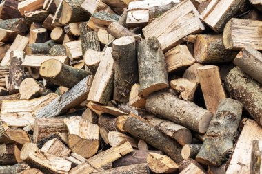 A pile of sawed firewood for heating in winter. Stockpile of firewood during the energy crisis