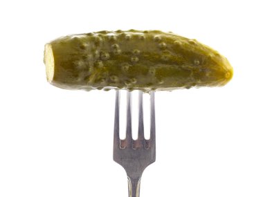 Pickled cucumber with a fork on a white background, isolated with shadow