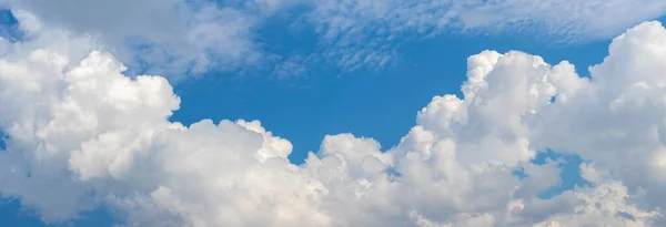 Stock image Large white curly clouds in the blue sky