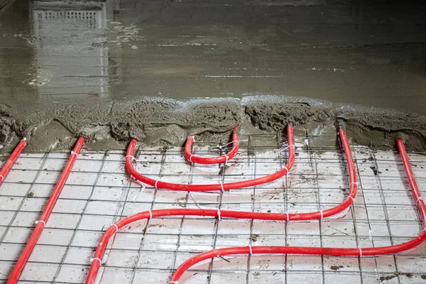 Installation of polypropylene pipes for underfloor heating systems, pouring the floor with concrete