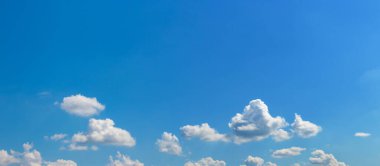 blue sky with small white curly clouds in sunny weather