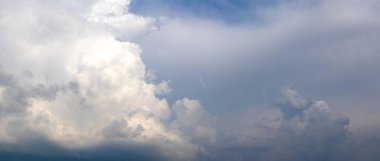 white curly cloud in a stormy sky clipart