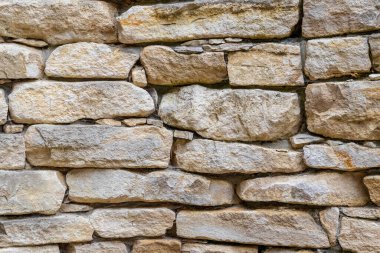 Düzensiz şekilli bloklardan oluşan eski taş duvar, doku, mimari, inşaat, arkaplan, tarihi yapı