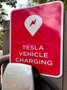 BRISBANE - FEB 07 2023:TESLA electric vehicle charge point sign. Tesla's plan to open up its Supercharger network to non-Tesla electric vehicles