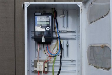 KERKERI, NZL - 25 Ocak 2023: Ev akıllı metresi, elektrik enerjisi tüketimi, voltaj seviyesi, akım ve güç faktörü gibi bilgileri kaydeden elektronik bir cihaz.