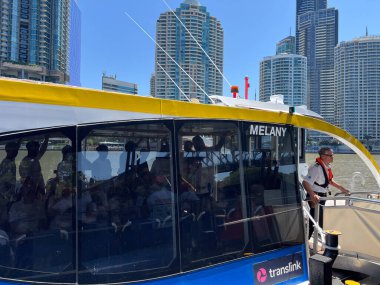 BRISBANE - OCT 06 2024:KittyCat ferry driver sail on Brisbane river Queensland Australia. RiverCity Ferries operates 32 vessels serving 21 wharves on the Brisbane River under a ten-year contract. clipart