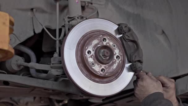 Mechanic Removes Brake Discs Car Screwdriver Change Pads Workshop Footage — Stock Video