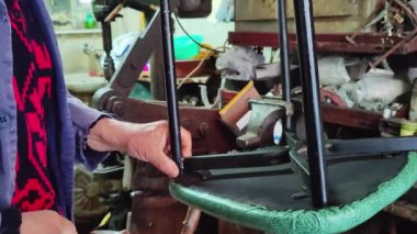 Old Man Repairing Broken Metal Chair Leg With Electric Welding Footage.