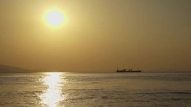 Ocean and Ship on Horizon at Sunset in Cold Winter Footage.