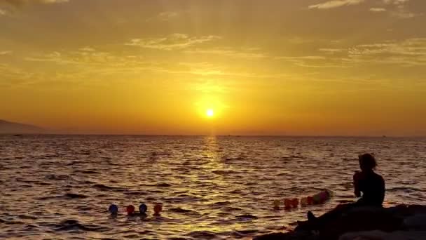 งบนหน าผาชายหาดท Yellow Sunset และถ ายร บโทรศ อของเธอ — วีดีโอสต็อก