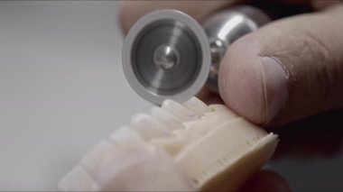 Dental Technician Shapes Implant Zirconium Coating with Milling Footage.