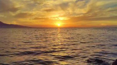 Yellow Sunset Over the Ocean and Mountains on the Horizon in the Autumn Viage.