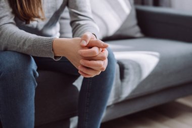 Tanımlanamayan bir kadın dizlerinin üstüne çökmüş, tek başına koltukta oturuyor, üzgün bir kız kendini yalnız hissediyor, aile içi şiddetten ya da ilişki probleminden muzdarip, erkek arkadaşından ayrılıyor.
