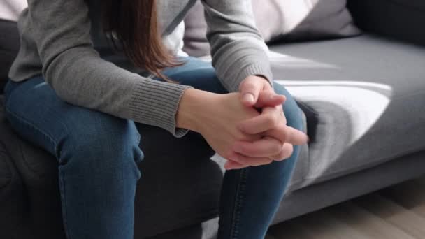 Close Unhappy Woman Folded Hands Knees Together Sitting Couch Alone — Stock Video