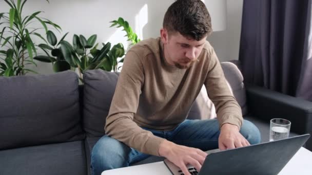 Wrist Pain Young Caucasian Man Sitting Couch Home Using Computer — Stock Video