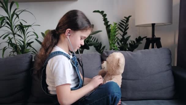 Little Child Plays Teddy Bear Sitting Cozy Couch Home Childhood — Video Stock