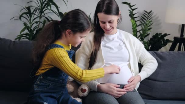 Smiling Pregnant Mother Playful Little Daughter Hold Teddy Bear Showing — Stockvideo