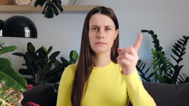 Portrait Young Caucasian Woman Warns Sitting Sofa Home Frowning Serious — Stock Video