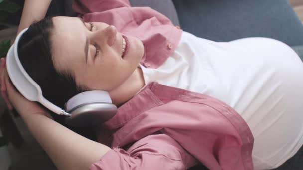 Крупним Планом Вид Розслабленої Вагітної Жінки Слухає Музику Бездротовими Навушниками — стокове відео