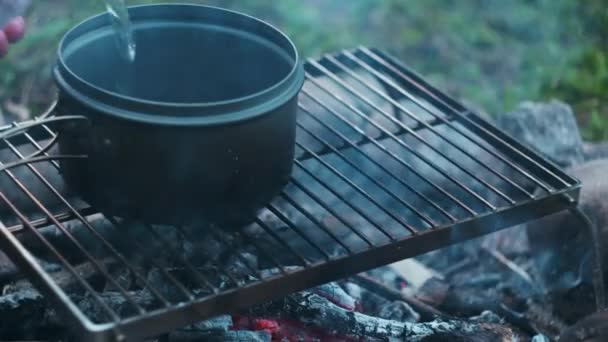 Close Child Hands Pouring Water Camp Pot Campfire Evening Summertime — Stock Video