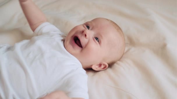Portrait Cute Newborn Laughs Resting Comfortable Bed Smiling Awakened Three — Stock Video