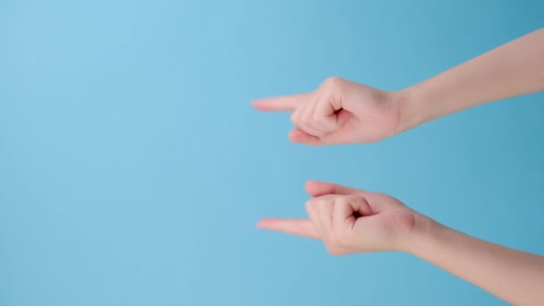 女性手指头指向蓝色空空间商业背景环上的空白区域的垂直视频 推荐标志 带有文字或图像的位置 特殊报价概念 — 图库视频影像