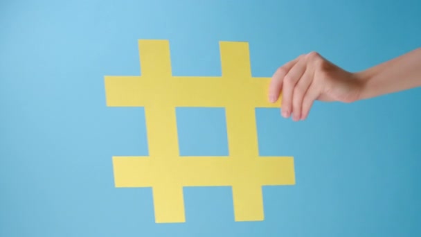 Vertical Video Female Hands Holding Large Yellow Paper Hashtag Symbol — Stock Video