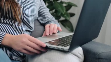 Modern kişisel bilgisayarın klavyesinde yazan kadın ellerini kapat. Ofiste rahat bir koltukta otururken e-posta yazan Kafkasyalı genç bir iş kadını. İş konsepti