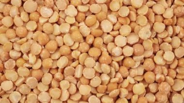 Yulaf lapası pişirmek için yuvarlak sarı bezelyeler, pişirmeden önce etrafa saçılmış çiğ bezelyeler. Sağlıklı gıda konsepti. Kurumuş bezelyelerin üst görünümü