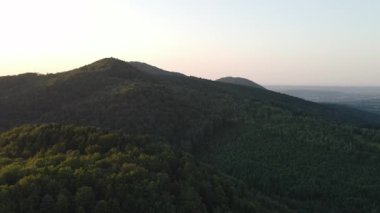 Yaz günbatımında güzel dağlardaki yeşil ağaçların muhteşem destansı insansız hava aracı görüntüsü. Açık hava yaşam tarzı sağlıklı ve temiz hava için. Gezgin şehvet ve doğa konsepti