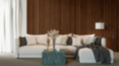 Modern bir oturma odasının bulanık arka planı, parlak ve solunabilir, doğal ışık, mobilyalar ve davetkar koltuk düzenlemeleri, sessiz ve stil bir atmosfer yaratıyor.