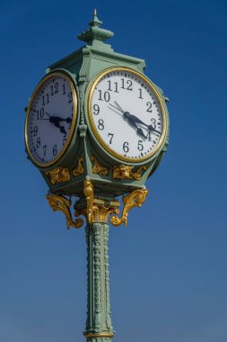 The Wise and Son historic clock on the Riis Park boardwalk in New York clipart