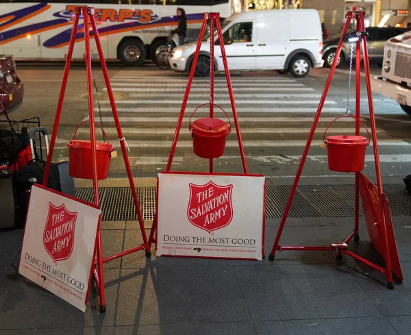 Salvation Army red kettles for collections in midtown Manhattan. This Christian organization is known for its charity work, operating in 126 countries