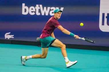 MIAMI GARDENS, FLORIDA - MARCH 29, 2023: Jannik Sinner of Italy in action during quarter-final match against Emil Ruusuvuori of Finland at 2023 Miami Open at the Hard Rock Stadium in Miami Gardens, Florida, USA clipart