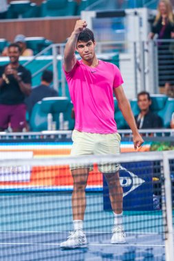 MIAMI GARDENS, FLORIDA - MARCH 29, 2023: Carlos Alcaraz of Spain celebrates victory after quarter-final match against Taylor Fritz of USA at 2023 Miami Open at the Hard Rock Stadium in Miami Gardens, Florida, USA clipart