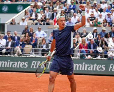 PARIS, FRANCE - MAY 30, 2022: Professional tennis player Holger Rune of Denmark in action during his round 4 match against Stefanos Tsitsipas of Greece at 2022 Roland Garros in Paris, France