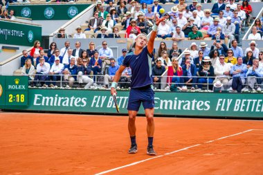 PARIS, FRANCE - MAY 30, 2022: Professional tennis player Holger Rune of Denmark in action during his round 4 match against Stefanos Tsitsipas of Greece at 2022 Roland Garros in Paris, France