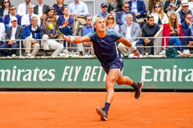 PARIS, FRANCE - MAY 30, 2022: Professional tennis player Holger Rune of Denmark in action during his round 4 match against Stefanos Tsitsipas of Greece at 2022 Roland Garros in Paris, France