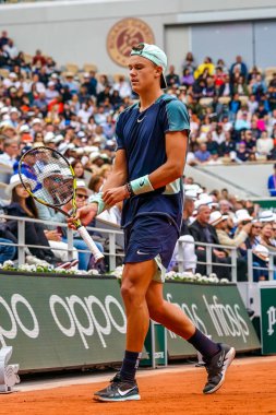 PARIS, FRANCE - MAY 30, 2022: Professional tennis player Holger Rune of Denmark in action during his round 4 match against Stefanos Tsitsipas of Greece at 2022 Roland Garros in Paris, France