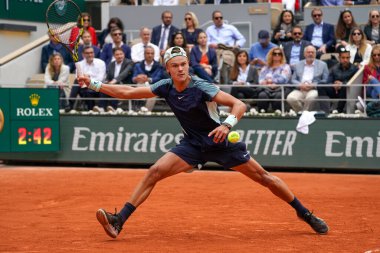 PARIS, FRANCE - MAY 30, 2022: Professional tennis player Holger Rune of Denmark in action during his round 4 match against Stefanos Tsitsipas of Greece at 2022 Roland Garros in Paris, France